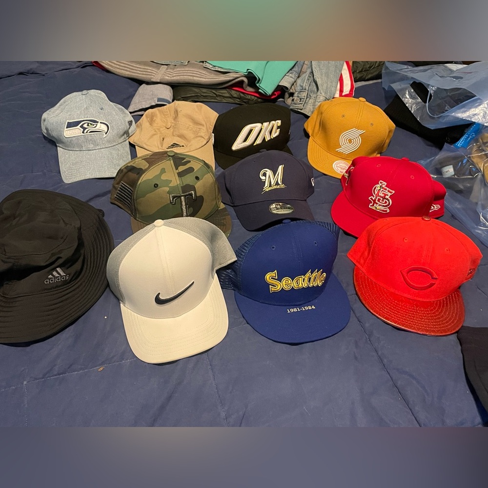 Lot athletic hats different colors and styles.